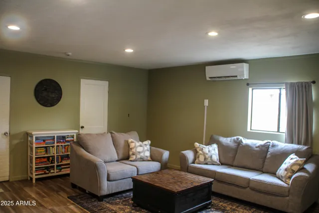 a living room with furniture a window and a lamp