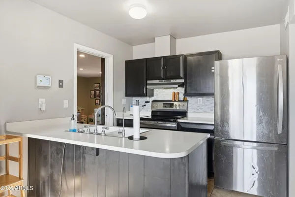 a kitchen with kitchen island a sink stainless steel appliances and cabinets