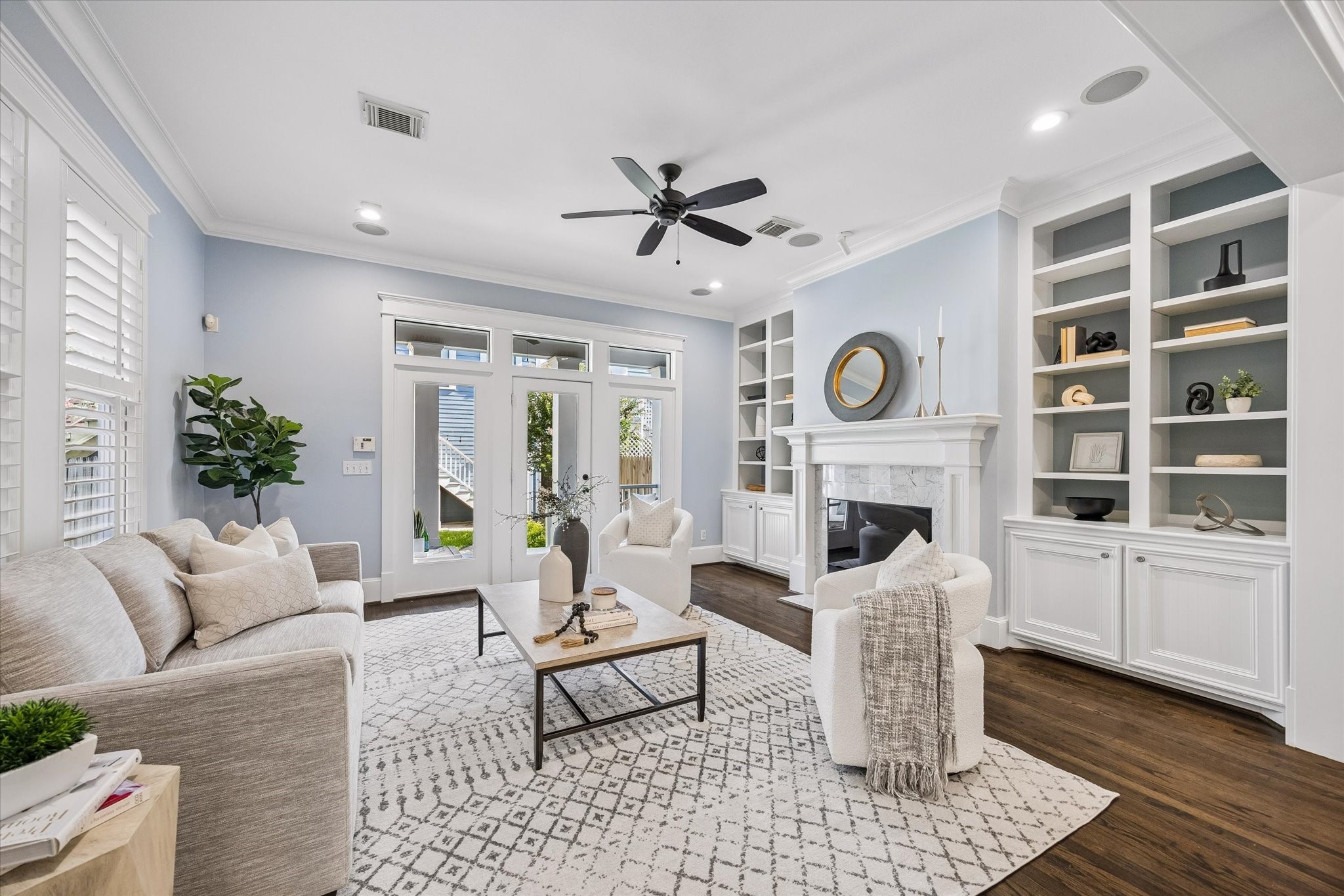 634 West 17th Street Houston, TX 77008 - Photo 15 of 42 Built-ins frame the gas-log fireplace and add timeless character, while the wall of glass brings in soft natural light. A glass door opens to the covered back porch for effortless indoor-outdoor living and entertaining.
