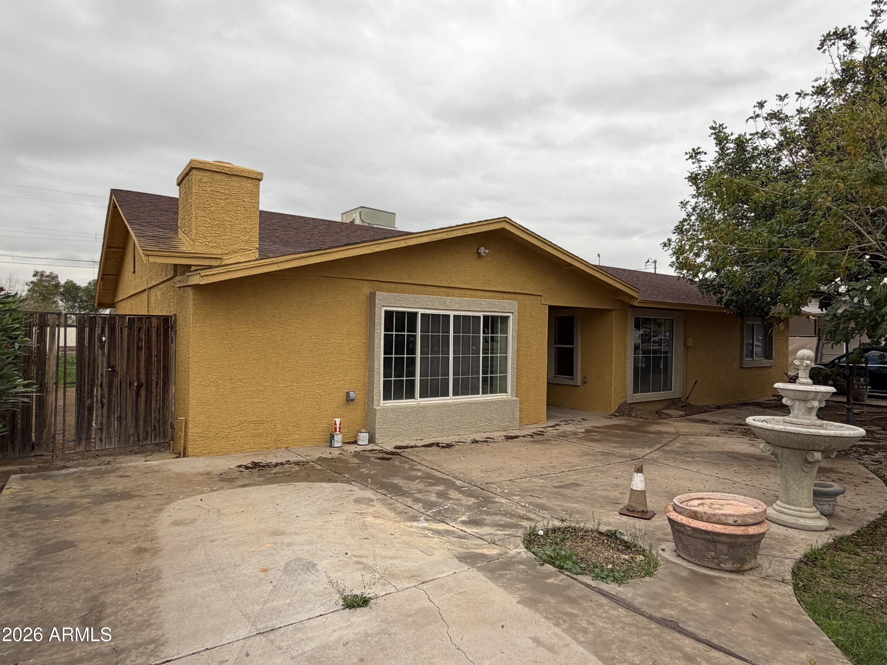 a front view of a house with yard outdoor seating and barbeque oven