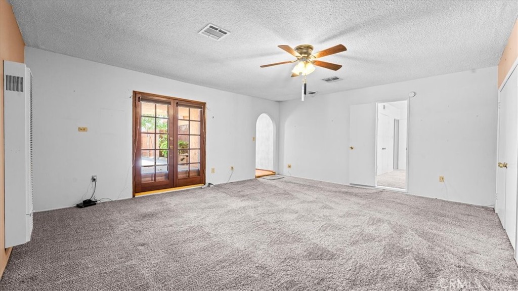 27196 10th Street Highland, CA 92346 - Photo 11 of 42 an empty room with windows and fan