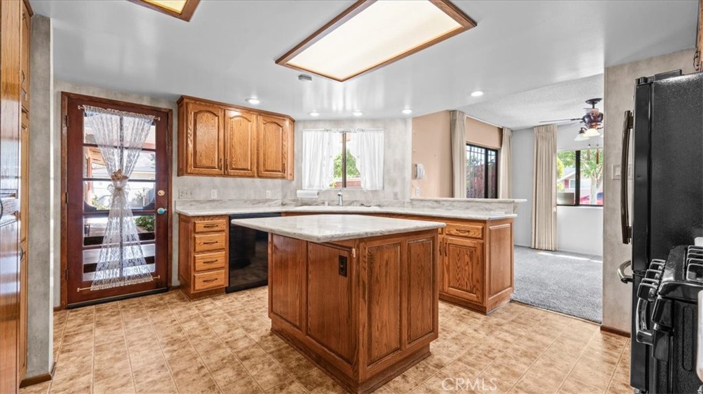 27196 10th Street Highland, CA 92346 - Photo 13 of 42 a kitchen with stainless steel appliances granite countertop a sink stove and refrigerator