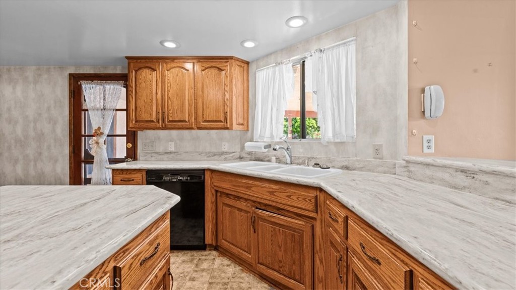 27196 10th Street Highland, CA 92346 - Photo 14 of 42 a kitchen with a sink stove and cabinets