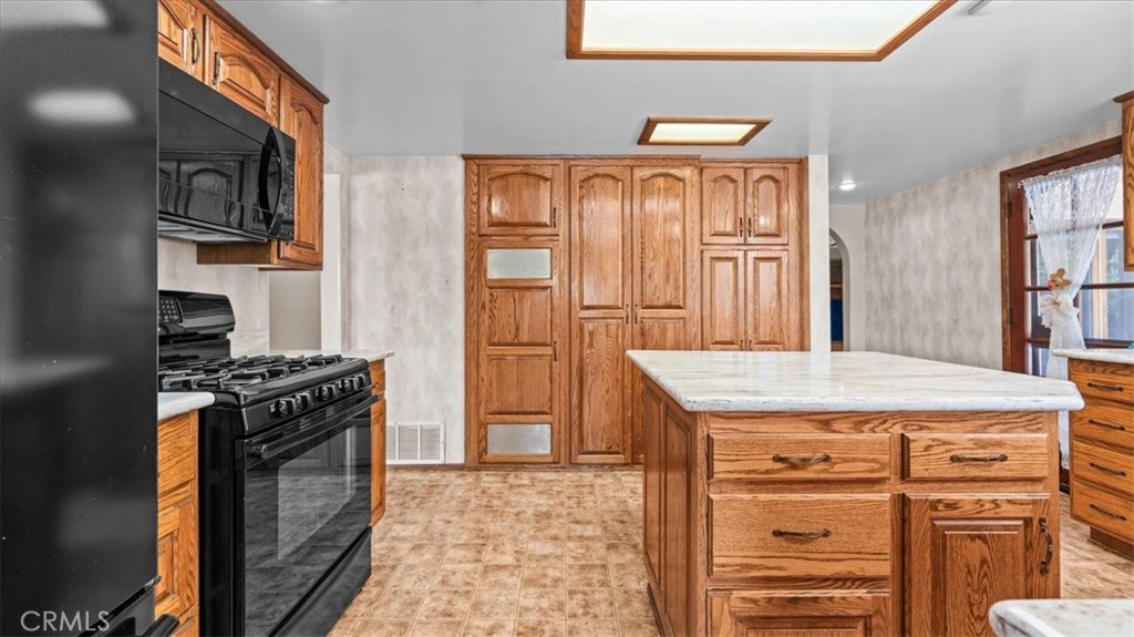 27196 10th Street Highland, CA 92346 - Photo 15 of 42 a kitchen with a stove and a refrigerator