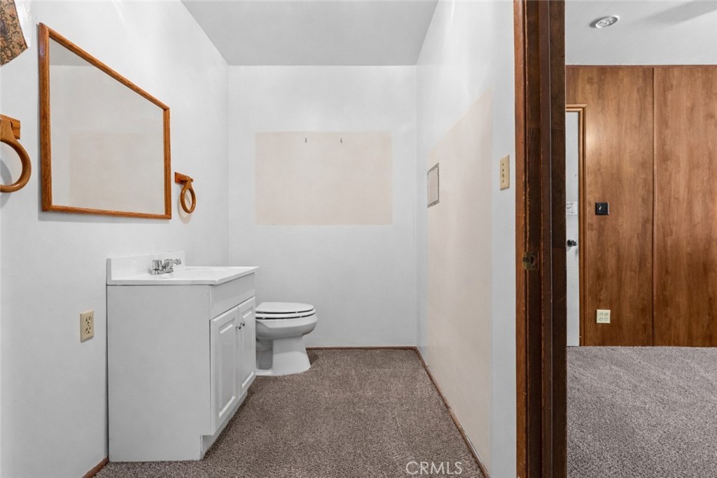 27196 10th Street Highland, CA 92346 - Photo 18 of 42 a bathroom with a sink a toilet and mirror