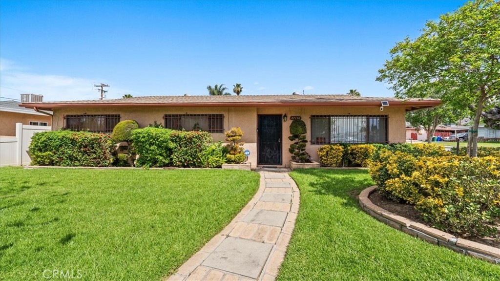 27196 10th Street Highland, CA 92346 - Photo 2 of 42 a front view of a house with a yard