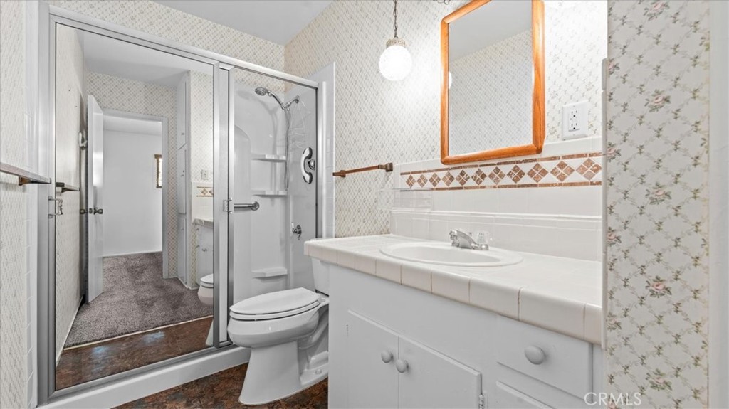 27196 10th Street Highland, CA 92346 - Photo 24 of 42 a bathroom with a sink a toilet and shower