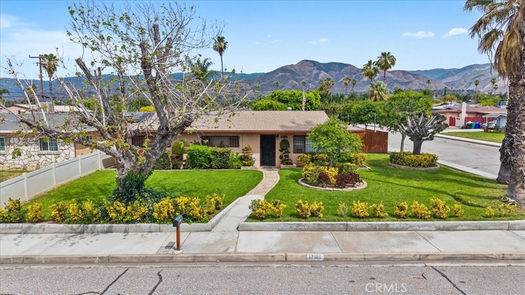 27196 10th Street Highland, CA 92346 - Photo 36 of 42 a front view of a house with a yard and potted plants