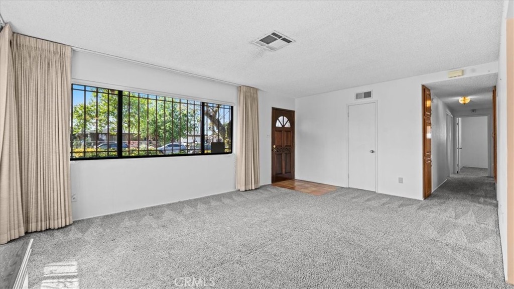 27196 10th Street Highland, CA 92346 - Photo 6 of 42 a view of an empty room with a window