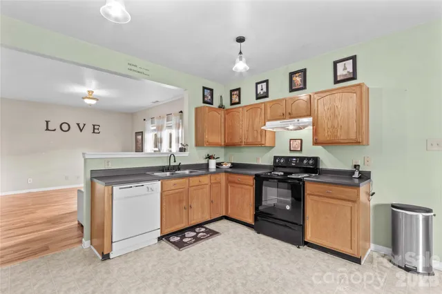 a kitchen with stainless steel appliances granite countertop a stove and a sink