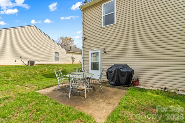 a view of a backyard with large trees