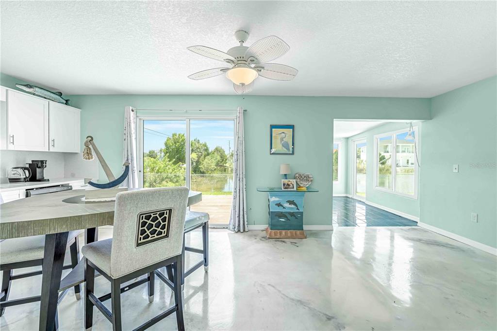 3379 Crape Myrtle Drive Hernando Beach, FL 34607 - Photo 17 of 68 a view of a dining room with furniture window and outside view