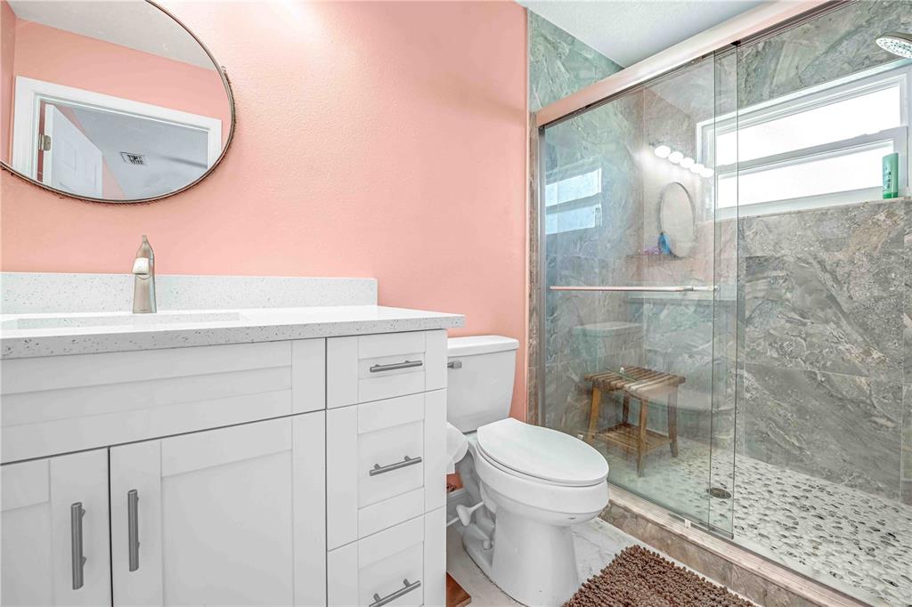 3379 Crape Myrtle Drive Hernando Beach, FL 34607 - Photo 19 of 68 a bathroom with a sink a toilet and a mirror