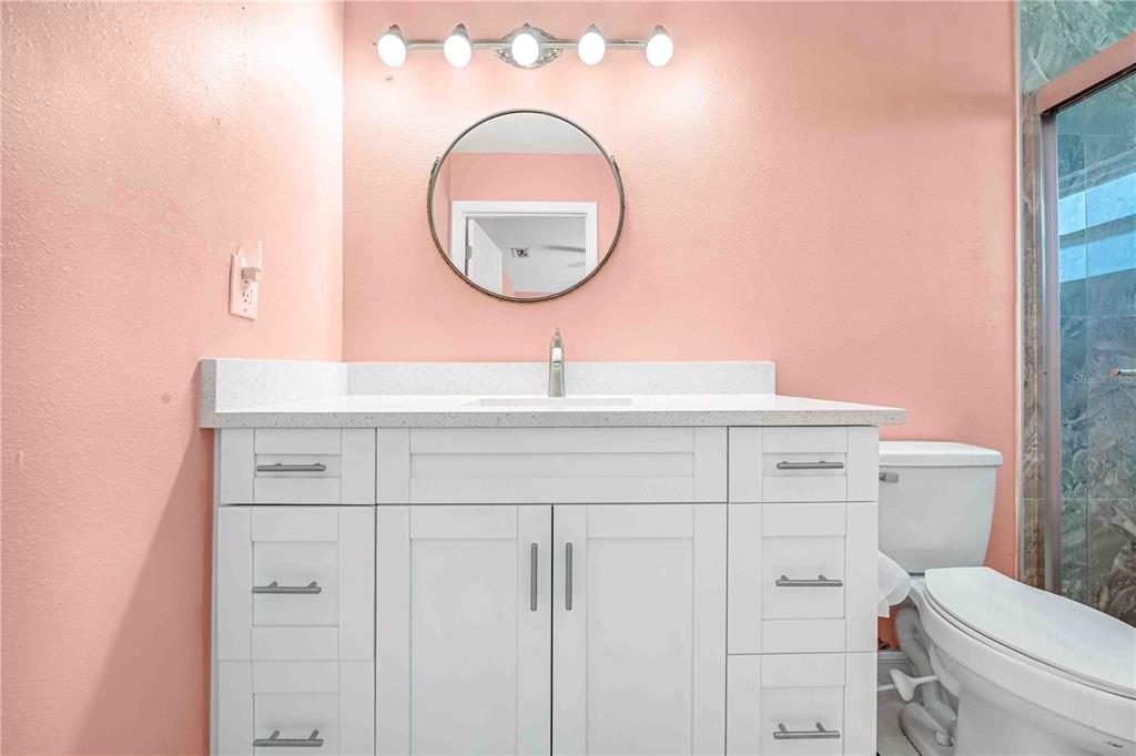 3379 Crape Myrtle Drive Hernando Beach, FL 34607 - Photo 20 of 68 a bathroom with a sink a toilet and a mirror