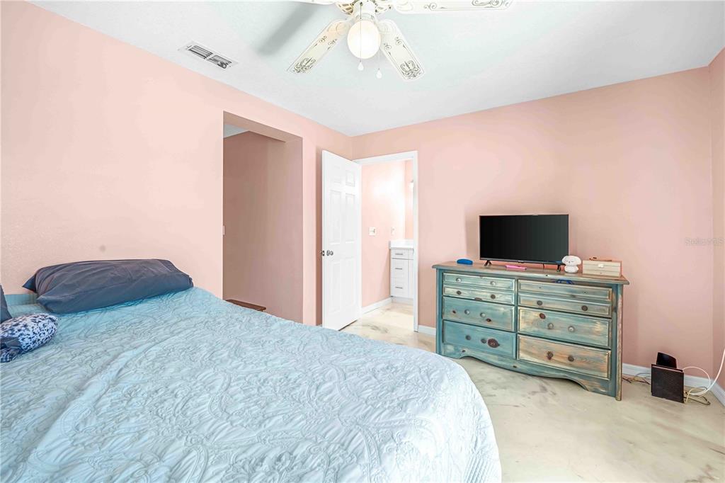 3379 Crape Myrtle Drive Hernando Beach, FL 34607 - Photo 21 of 68 a bedroom with a bed and a television