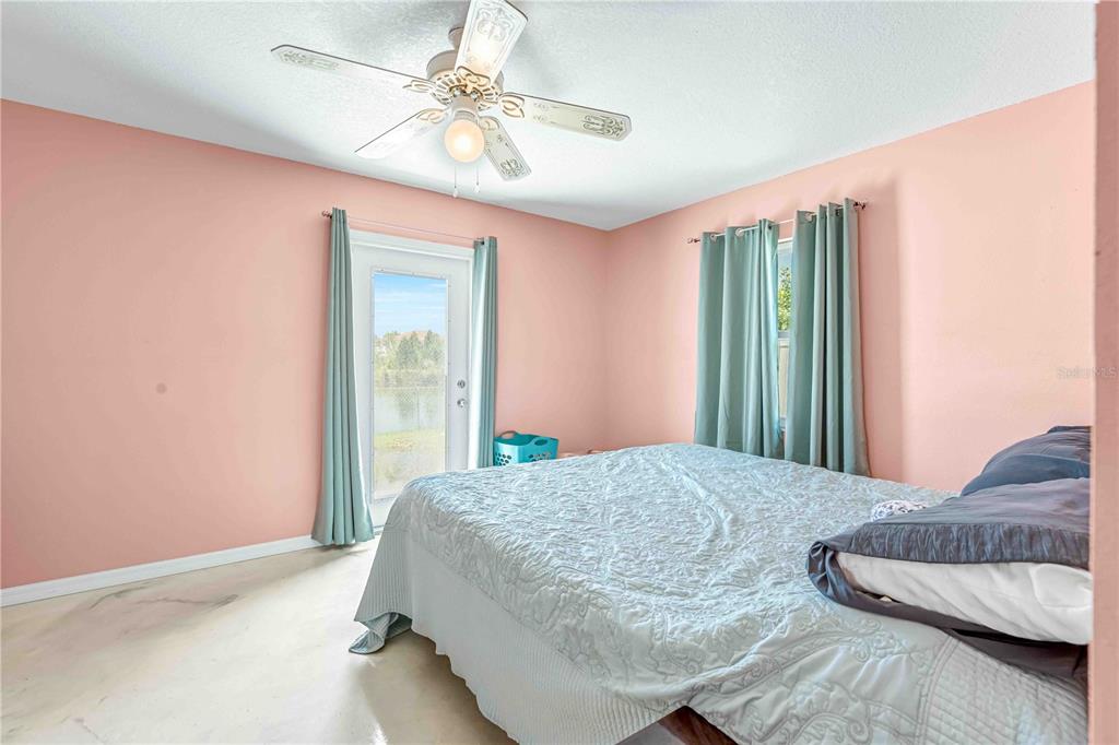 3379 Crape Myrtle Drive Hernando Beach, FL 34607 - Photo 23 of 68 a bedroom with a bed and a chandelier