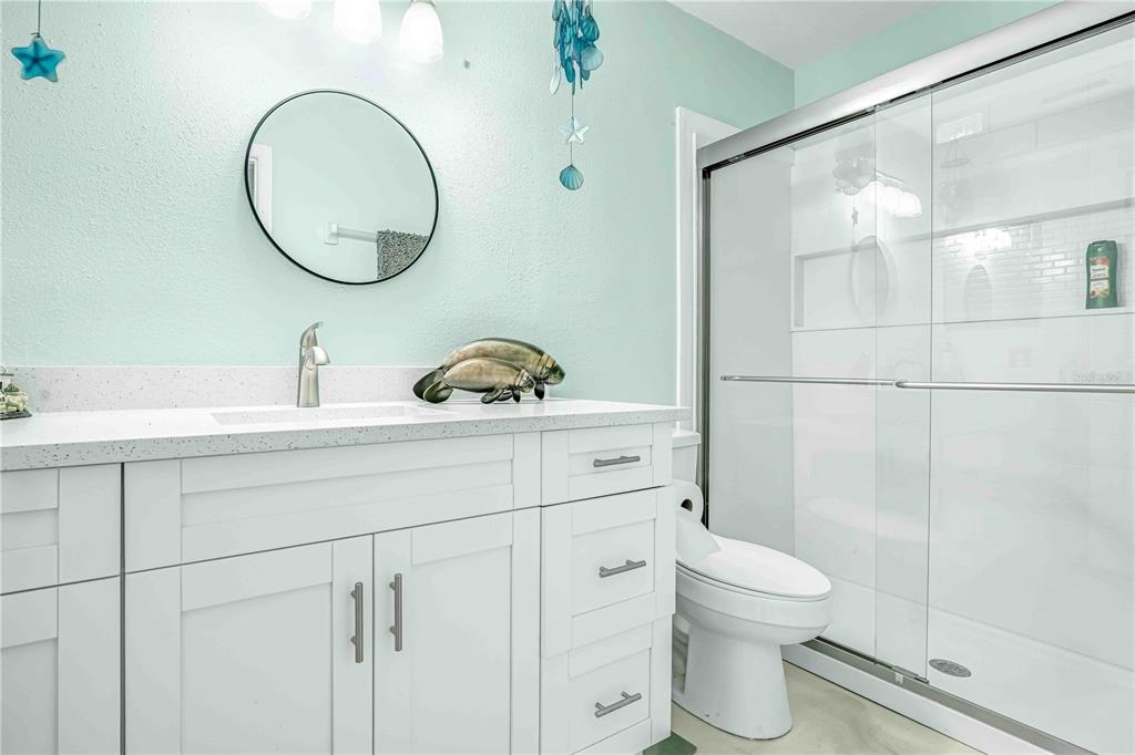 3379 Crape Myrtle Drive Hernando Beach, FL 34607 - Photo 25 of 68 a bathroom with a toilet a sink and mirror