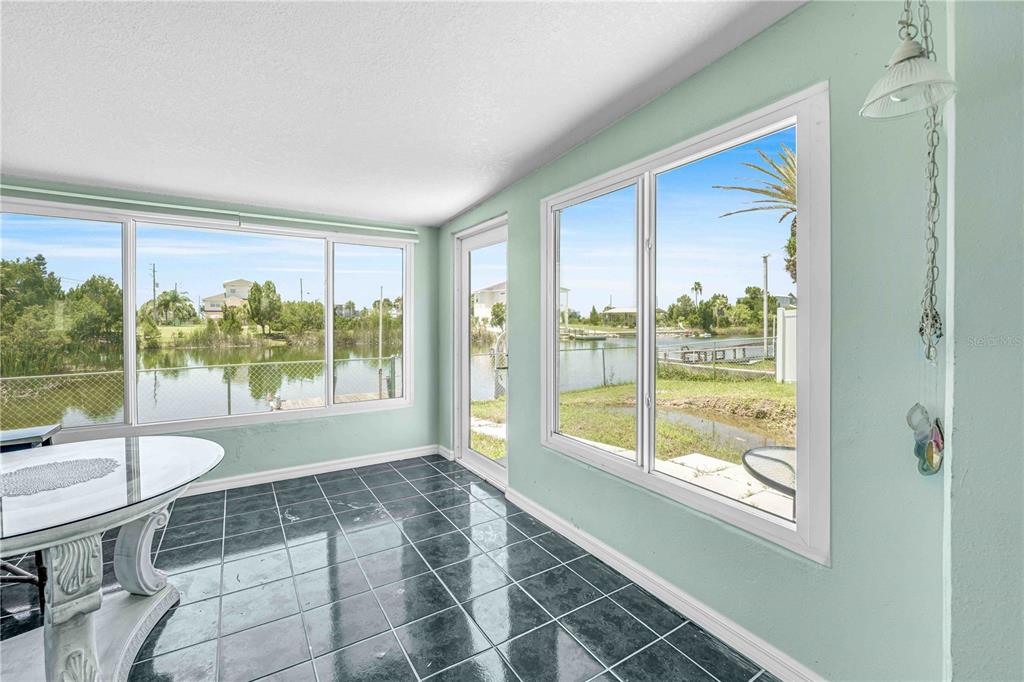 3379 Crape Myrtle Drive Hernando Beach, FL 34607 - Photo 33 of 68 a living room with a large window and a table