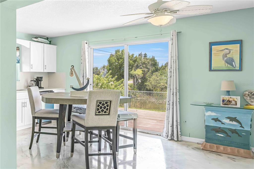 3379 Crape Myrtle Drive Hernando Beach, FL 34607 - Photo 37 of 68 a view of a dining room that has a table and chairs in it