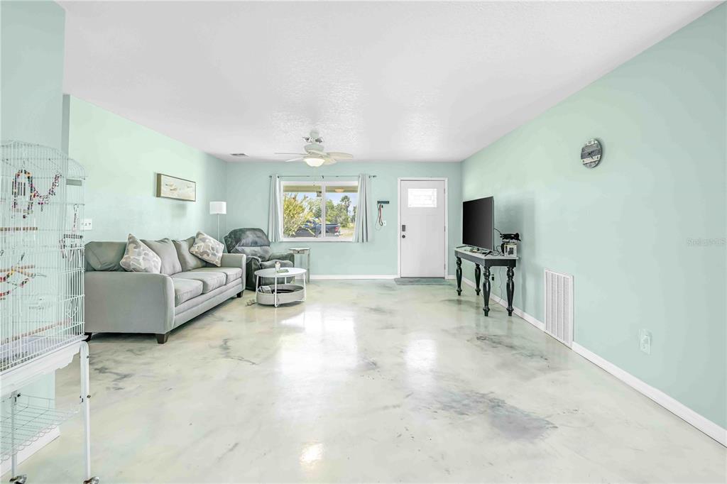 3379 Crape Myrtle Drive Hernando Beach, FL 34607 - Photo 39 of 68 a living room with furniture and a flat screen tv