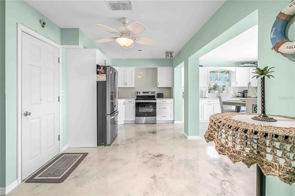 3379 Crape Myrtle Drive Hernando Beach, FL 34607 - Photo 40 of 68 a kitchen with stainless steel appliances kitchen island granite countertop a refrigerator and a stove top oven