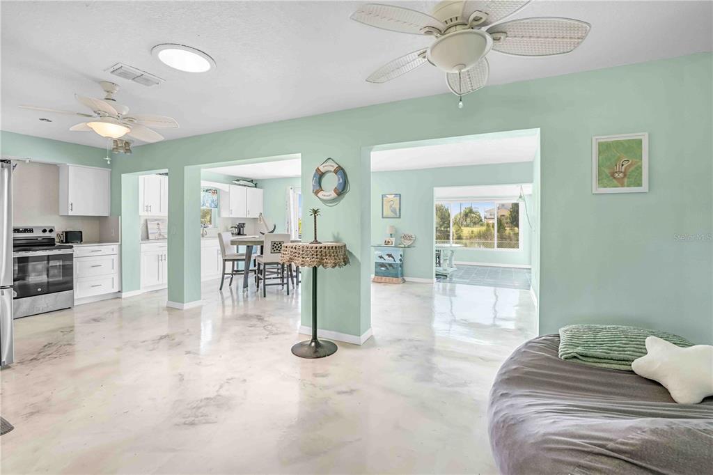 3379 Crape Myrtle Drive Hernando Beach, FL 34607 - Photo 41 of 68 a view of a livingroom with furniture and a chandelier fan
