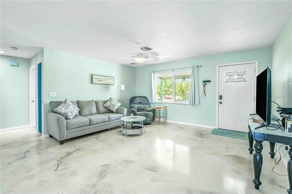 3379 Crape Myrtle Drive Hernando Beach, FL 34607 - Photo 45 of 68 a living room with furniture and a flat screen tv