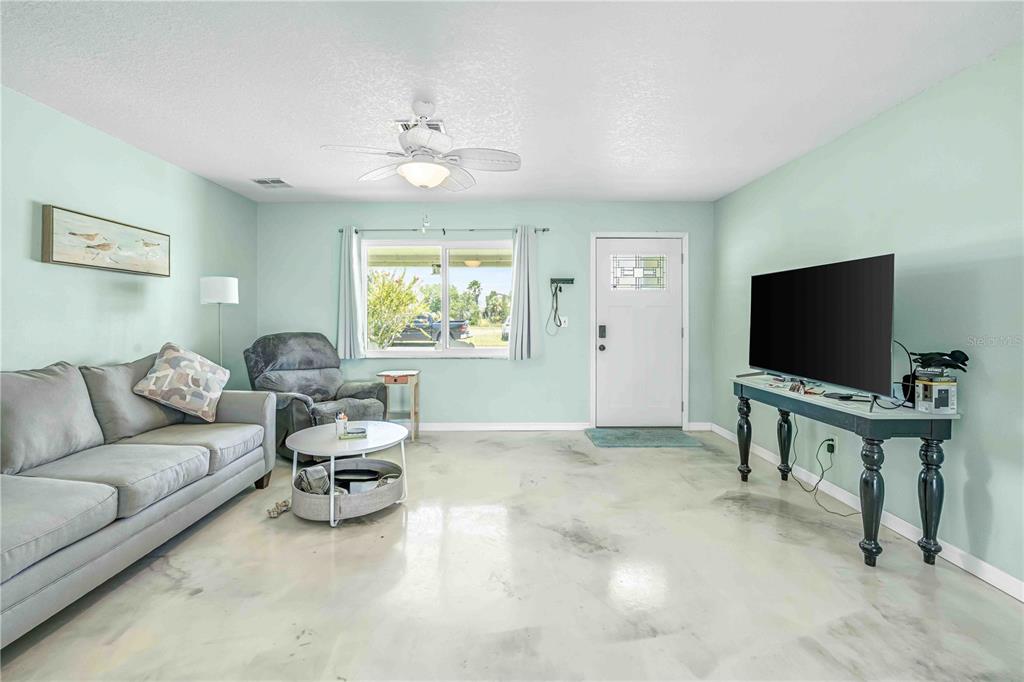 3379 Crape Myrtle Drive Hernando Beach, FL 34607 - Photo 46 of 68 a living room with furniture and a flat screen tv