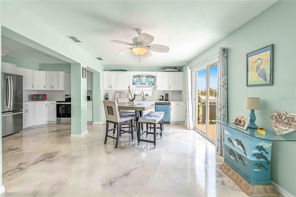 3379 Crape Myrtle Drive Hernando Beach, FL 34607 - Photo 6 of 68 a view of a dining room with furniture and a kitchen