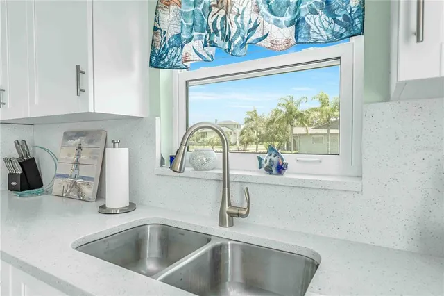 a dining room with wooden floor and chandelier
