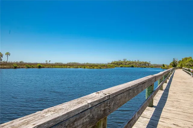 a kitchen with granite countertop white cabinets and chairs
