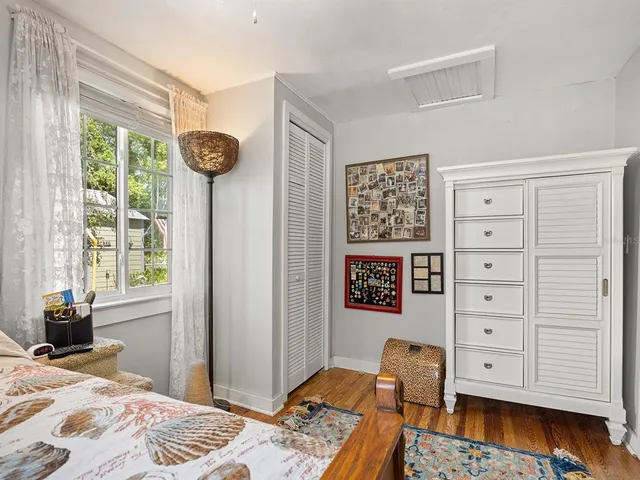 a bedroom with a bed and a window