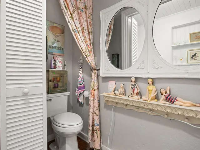 a bathroom with a toilet sink and mirror