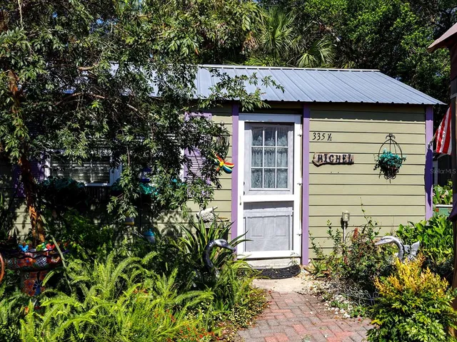 a view of a house with a flower garden