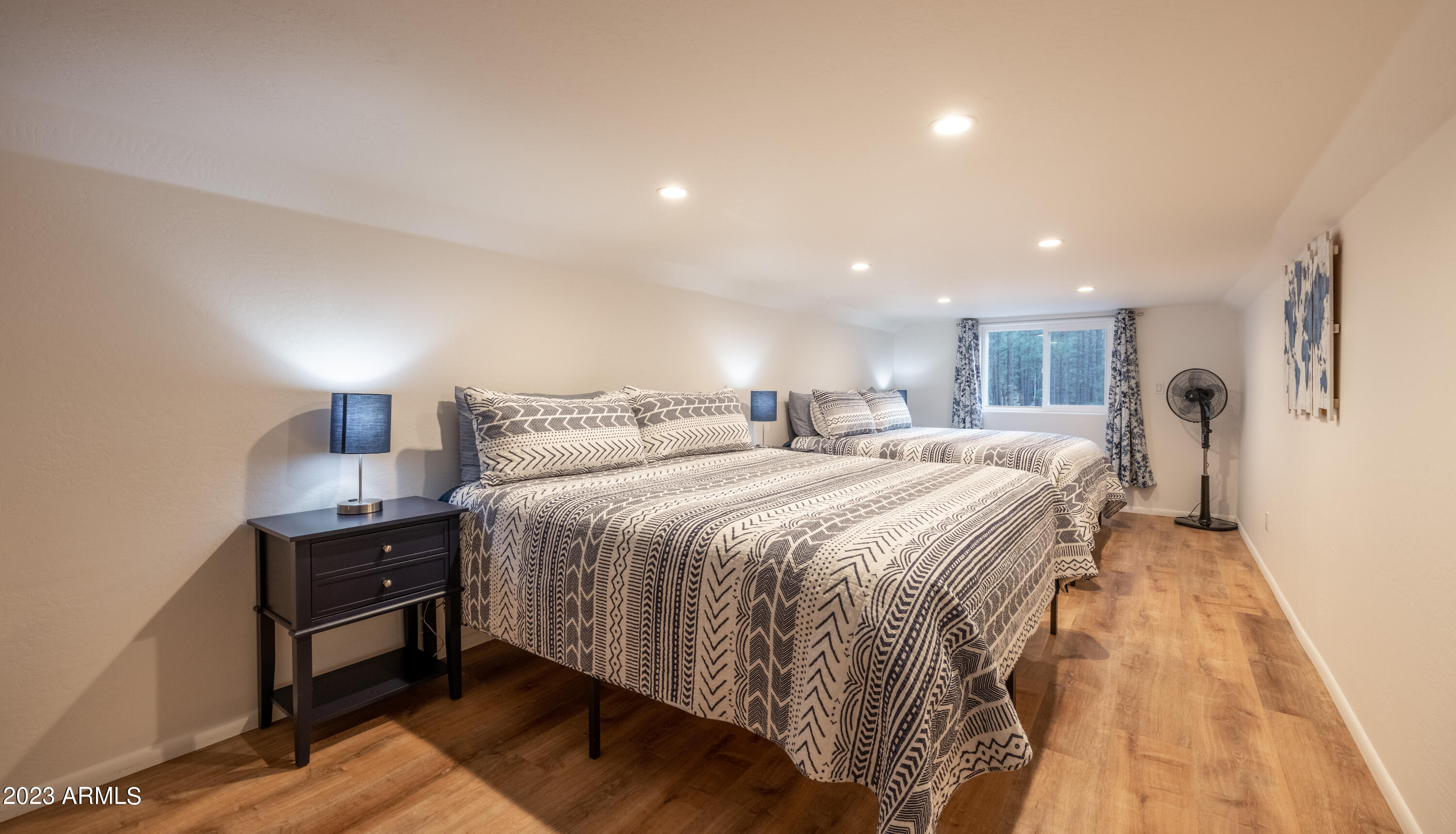 2772 Larson Loop Forest Lakes, AZ 85931 - Photo 38 of 65 a spacious bedroom with a bed and a lamp