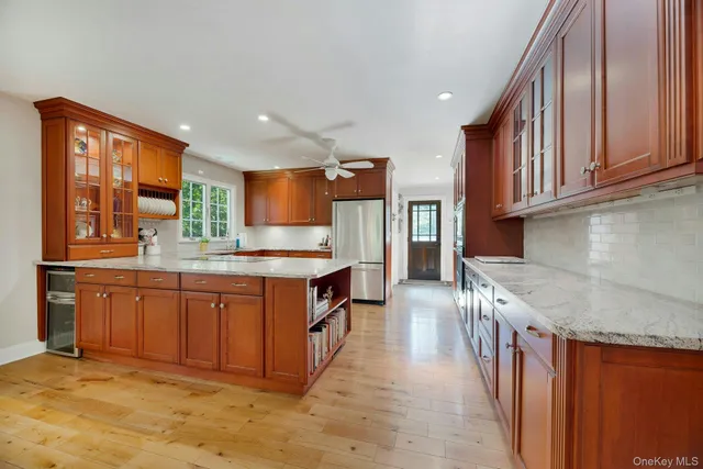 a kitchen with stainless steel appliances granite countertop a sink a stove and a refrigerator