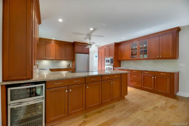 a kitchen with stainless steel appliances granite countertop wooden cabinets a stove top oven a sink and dishwasher