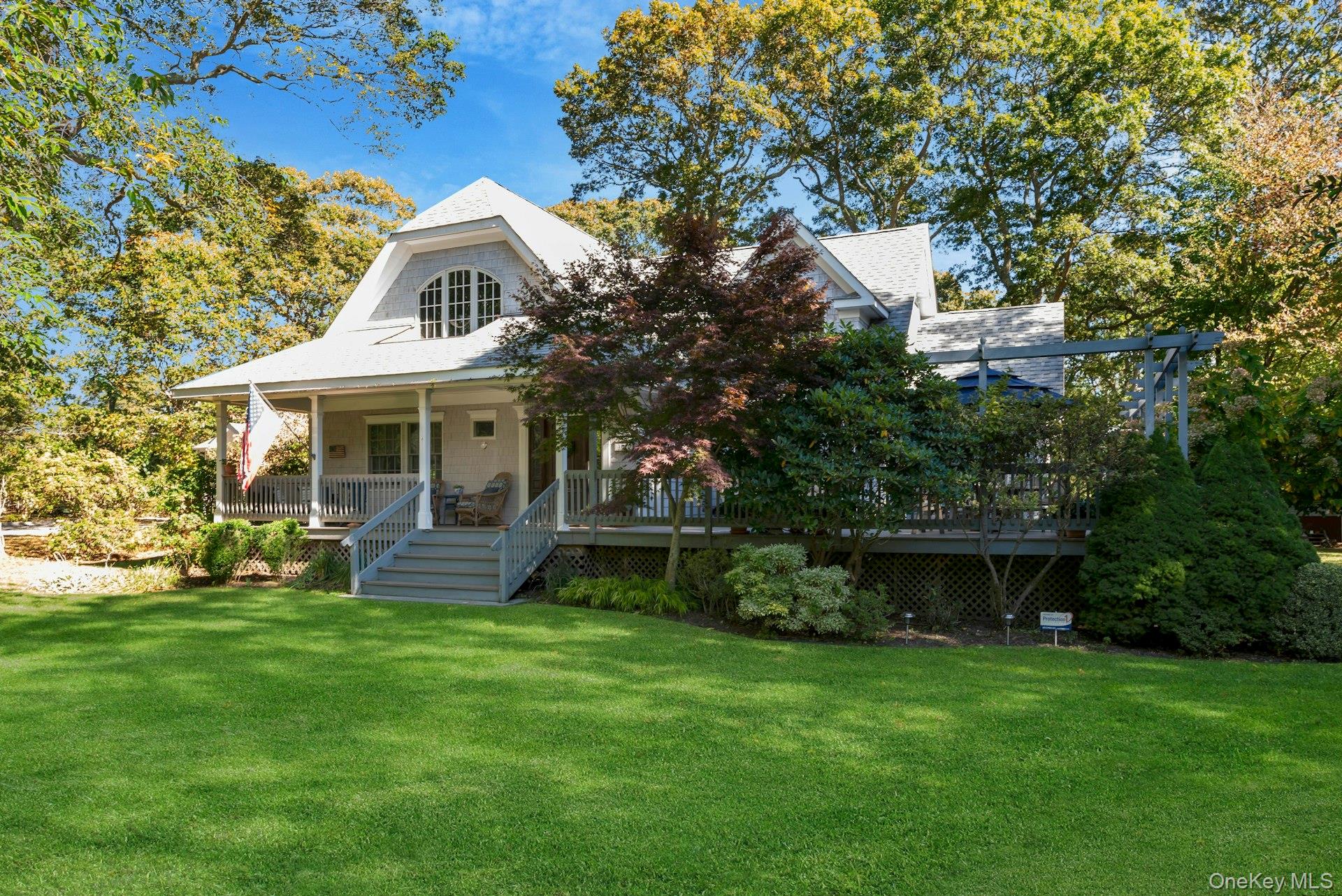 3600 Rocky Point Road East Marion, NY 11939 - Photo 2 of 45 a front view of a house with a garden and trees