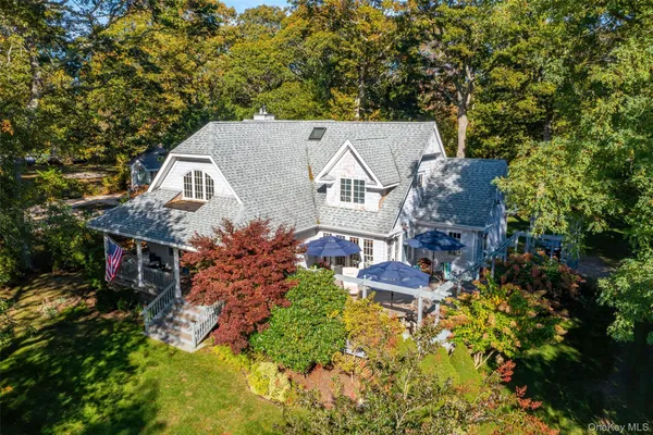 an aerial view of a house with a yard swimming pool a patio and outdoor seating