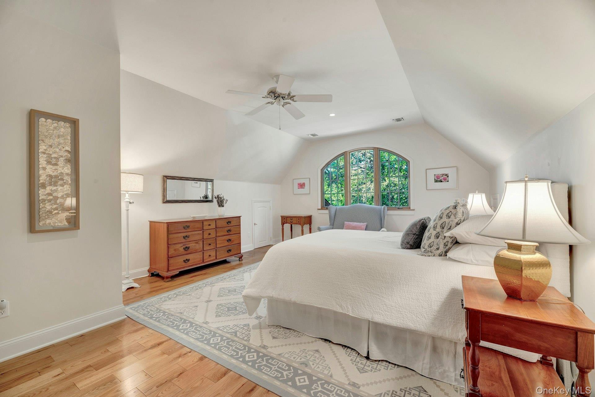 3600 Rocky Point Road East Marion, NY 11939 - Photo 23 of 45 a bedroom with a large bed and a chandelier