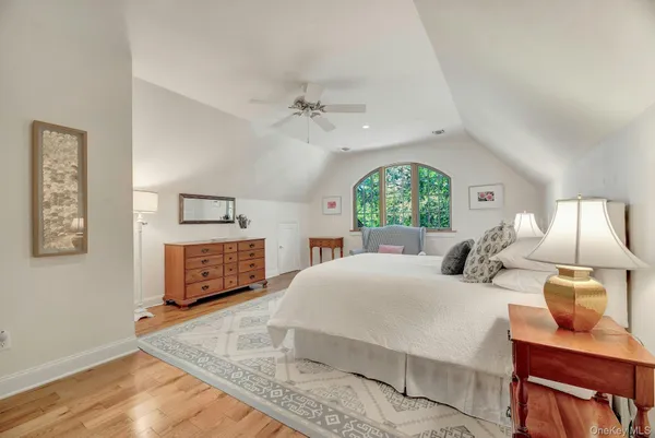 a bedroom with a bed and a chair