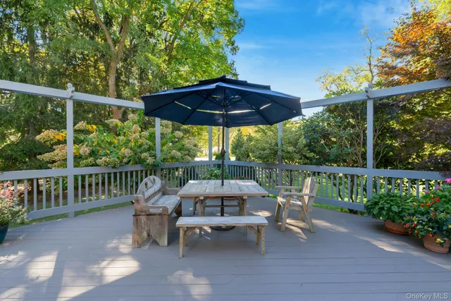 a view of a chair and table on the wooden deck