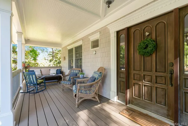 a balcony with furniture and wooden floor