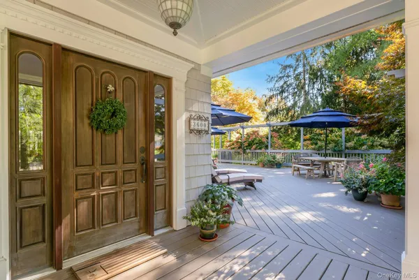 a view of a porch with furniture and a garden