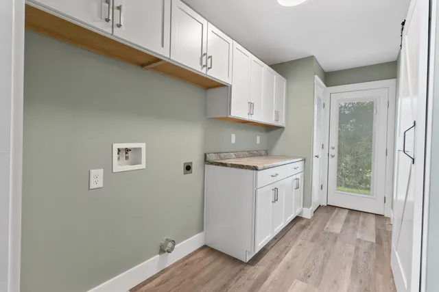 a kitchen with granite countertop white cabinets and white appliances
