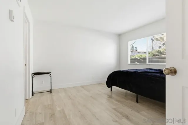 a bathroom with a granite countertop sink a toilet and a mirror