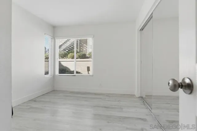 a bathroom with a sink a toilet a mirror and shower curtain
