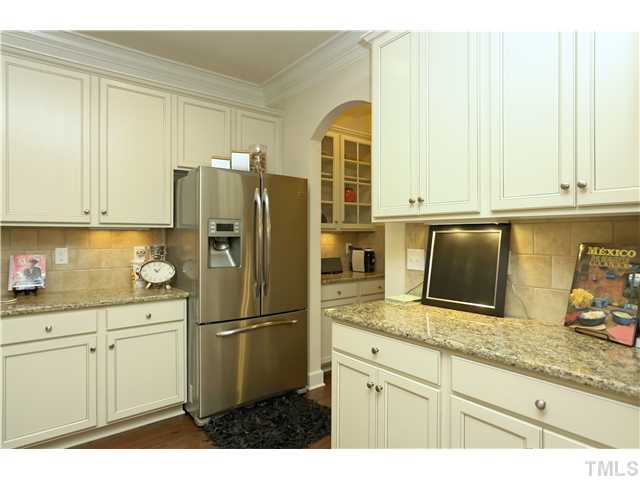 2327 Lowden Street Raleigh, NC 27608 - Photo 11 of 25 a kitchen with stainless steel appliances granite countertop a refrigerator sink and cabinets