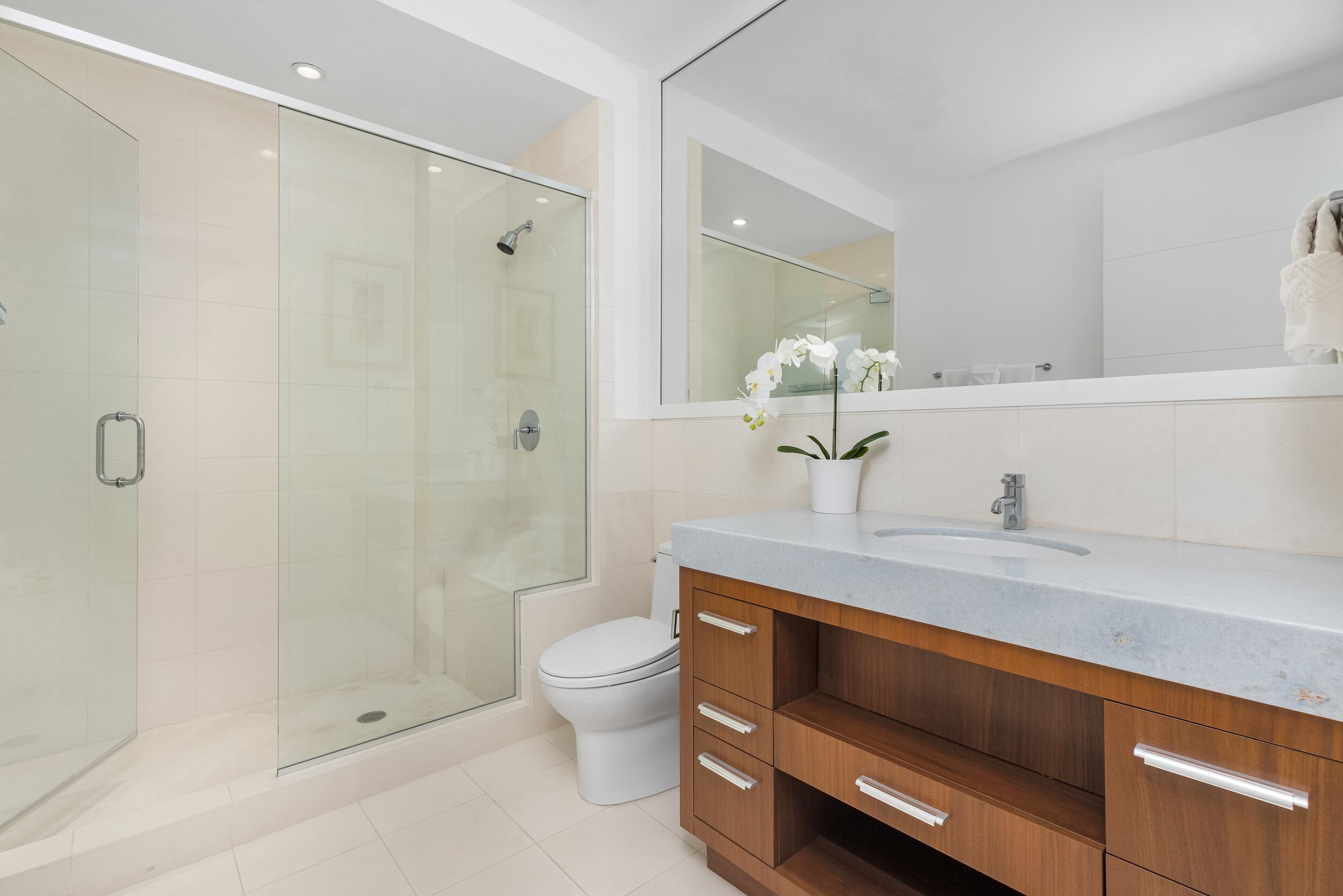 1000 South Ocean Boulevard, Unit 601 Boca Raton, FL 33432 - Photo 32 of 54 a bathroom with a sink a toilet and shower