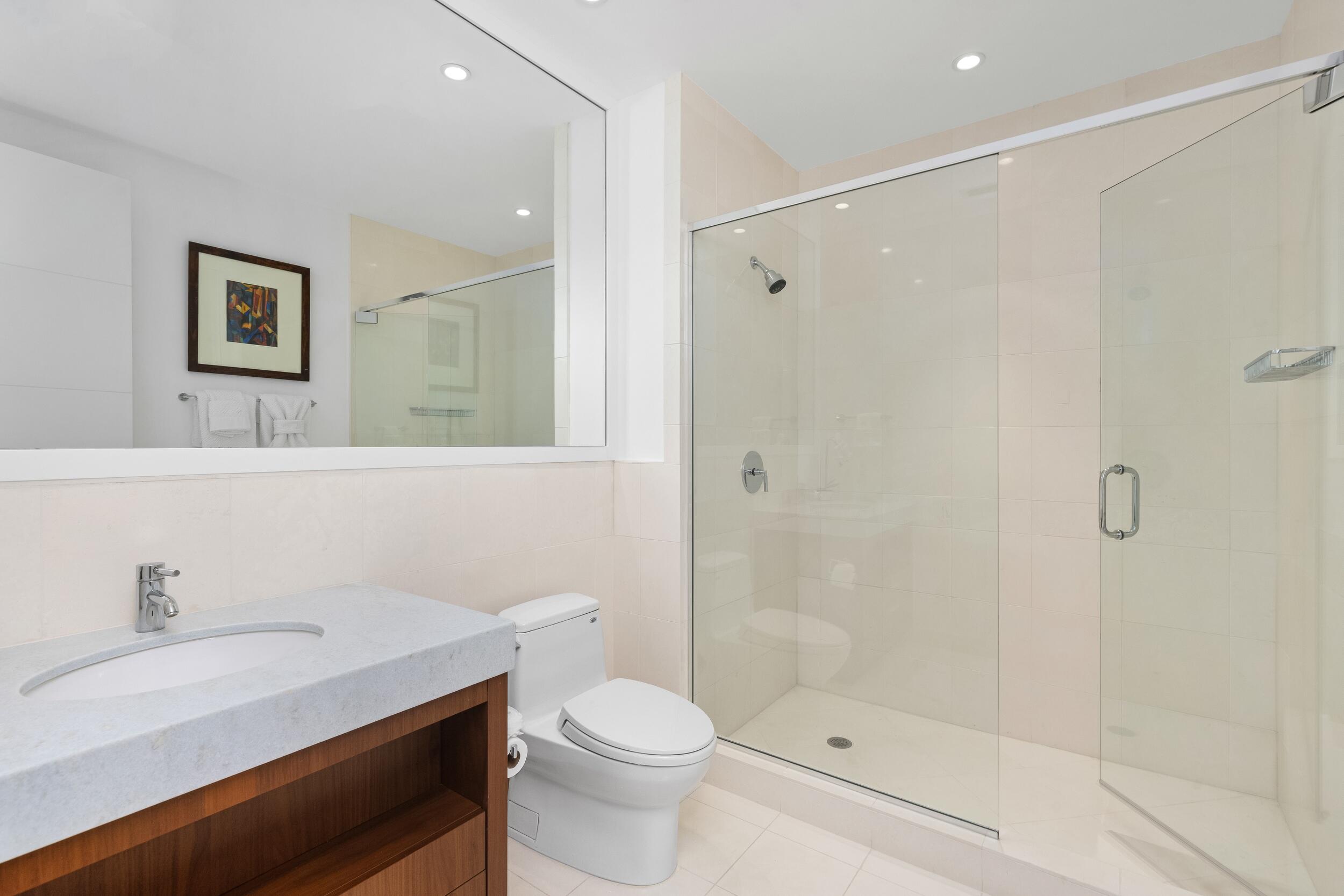 1000 South Ocean Boulevard, Unit 601 Boca Raton, FL 33432 - Photo 34 of 54 a bathroom with a sink a toilet and shower